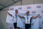 Retired U.S. Army Sgt. 1st. Class Greg Quarles, left, and Staff Sgt. Xavier Rodgers, right, pose for a photo after receiving gold medals for the upright tandem cycling event at the 2026 Warrior Games in San Antonio, Texas, June 14, 2026. The 2026 Warrior Games takes place June 13-20 in San Antonio, Texas, bringing together nearly 200 wounded, ill and injured service members and veterans from the U.S. Army, Marine Corps, Navy/Coast Guard, Air Force/Space Force, and U.S. Special Operations Command to compete across multiple adaptive sporting events. (U.S. Army photo by Spc. Jose Rolando Garcia)