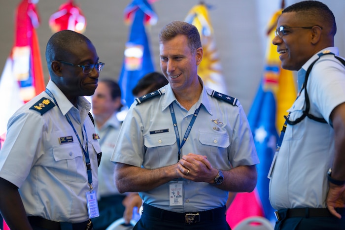 U.S. Air Force Maj. Gen. David Mineau, commander of 12th Air Force, Air Forces Southern, center, speaks with Jamaican Defense Force Lt. Col. Morton Stewart, executive officer for Maritime, Air and Cyber Command, left, and Maj. Noel Lewis, commander of the Jamaican Defense Force Air Wing, during the 66th annual Conference of the American Air Chiefs (CONJEFAMER) in Punta Cana, Dominican Republic, June 16, 2026. Face-to-face engagements during the conference helped to build the trust necessary to support future multinational cooperation. (U.S. Air Force photo by Tech. Sgt. Rachel Maxwell)