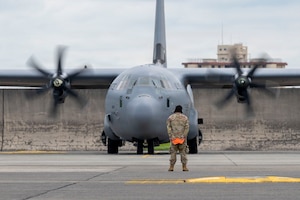 A U.S. Air Force Airman assigned to the 374th Airlift Wing marshals a C-130J Super Hercules assigned to the 36th Airlift Squadron during a rapid deployment training exercise at Yokota Air Base, Japan, June 23, 2026.