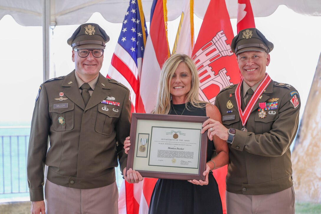 Monica Decker receives recognition from South Atlantic Division Commander Brig. Gen. Zachary Miller (left) for her support as a military spouse during the retirement ceremony for her husband, Col. Charles L. Decker (right). The Deckers concluded a 30-year joint service career that spanned both the U.S. Navy and U.S. Army, a period during which Decker oversaw major civil works, military construction, and disaster recovery missions that shaped USACE’s modern presence in the Caribbean.