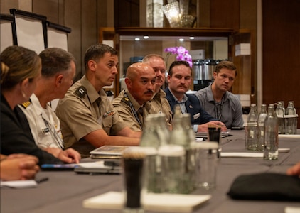Maj. Luis Torres, National Guard Bureau liaison officer to U.S. Indo-Pacific Command, or INDOPACOM, and Capt. Matthew Chartier, operations officer, 420th Chemical Battalion, 96th Troop Command, talk with others at the Indo-Pacific Health Security Summit, June 7, 2026, in Kuala Lumpur, Malaysia.