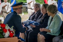 U.S. Army Capt. Christopher Barnabei, the Connecticut National Guard's casualty operations officer in charge, hands a folded American flag to the family of U.S. Army Air Forces Tech. Sgt. Donald A. Dorman at his funeral services at Oak Hill Cemetery, Southington, Connecticut, June 23, 2026.