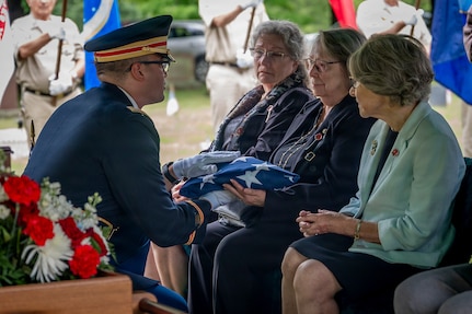U.S. Army Capt. Christopher Barnabei, the Connecticut National Guard's casualty operations officer in charge, hands a folded American flag to the family of U.S. Army Air Forces Tech. Sgt. Donald A. Dorman at his funeral services at Oak Hill Cemetery, Southington, Connecticut, June 23, 2026.