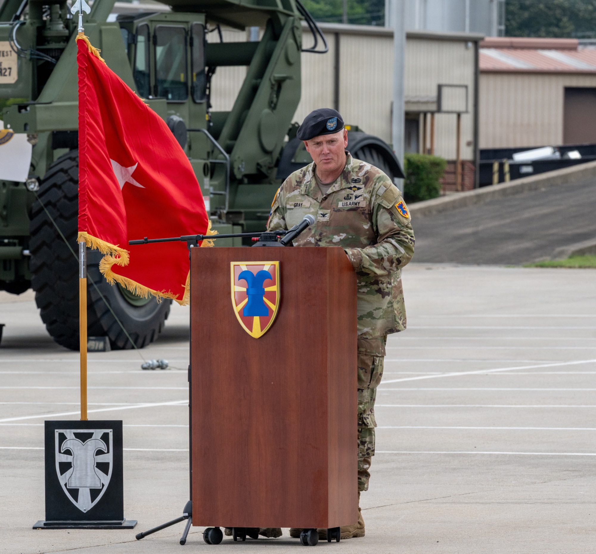 A Soldier speaks at a podium.