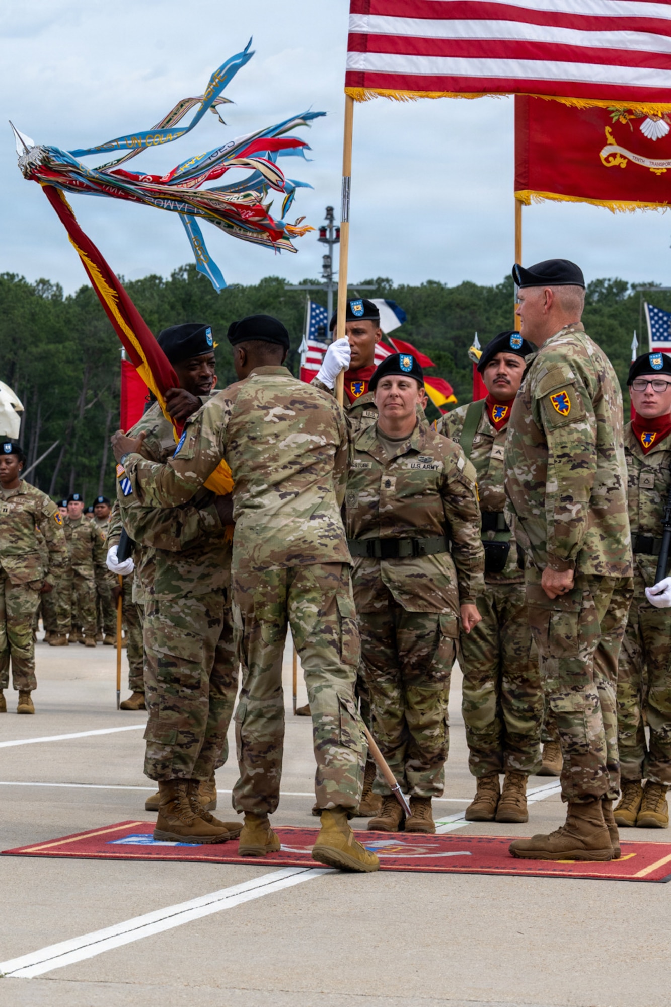 A General passes a flag to a Soldier.