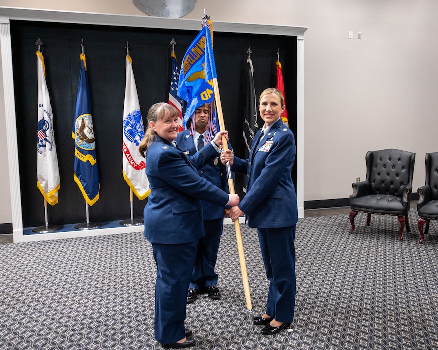 U.S. Air Force Col. La Rita Abel, left, Goodfellow Medical Group commander, passes the Goodfellow Operational Medical Readiness Squadron guidon to Lt Col. Tonya Toche-Howard, right, incoming GOMRS commander, during an assumption of command ceremony at Goodfellow Air Force Base, Texas, June 17, 2026. The passing of the guidon to Toche-Howard signifies her taking command of the GOMRS. (U.S. Air Force photo by Staff Sgt. Nathan Call)