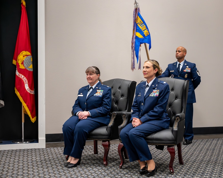 U.S. Air Force Lt Col. Tonya Toche-Howard, incoming Goodfellow Operational Medical Readiness Squadron commander, seated on the right, listens to the proctor during her assumption of command ceremony at Goodfellow Air Force Base, Texas, June 17, 2026. The assumption of command ceremony is a traditional event that symbolizes the transfer of authority of a unit. (U.S. Air Force photo by Staff Sgt. Nathan Call)