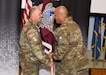 Col. Deon Maxwell, right, commander of U.S. Army Medical Logistics Command, passes the unit colors to Command Sgt. Maj. Andrew DeCola during a change of responsibility ceremony June 22 at Fort Detrick, Maryland. DeCola assumed responsibility as AMLC’s new senior enlisted adviser from Command Sgt. Maj. Gabriel Wright.