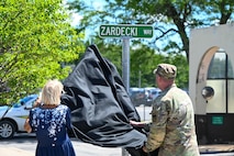 Photo of Col and mem of Zardecki family unveiling roadway sign