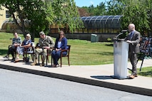 Photo of Deputy Commander Robert Lantka at podium with Tobyhanna command and Zardecki family in the background