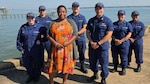 Coast Guard civilian Ronette Rhoden stands with military members from her TRACEN Yorktown unit on the base pier in Yorktown, Virginia on June 17, 2026.  Their support and dedication to the Coast Guard’s new Physical Readiness Program (PRP), she says, inspired her to get back into fitness. From left to right: SK1 Catherine Walker, SK3 Dominic Olivas, Rhoden, SK1 Roy Follman, Lt Cmdr. James Rizzo, Chief Warrant Officer Katie Underwood, SK3 Desteny Carranza-Velasquez. U.S. Coast Guard photo by Chief Warrant Officer Chad McNeil