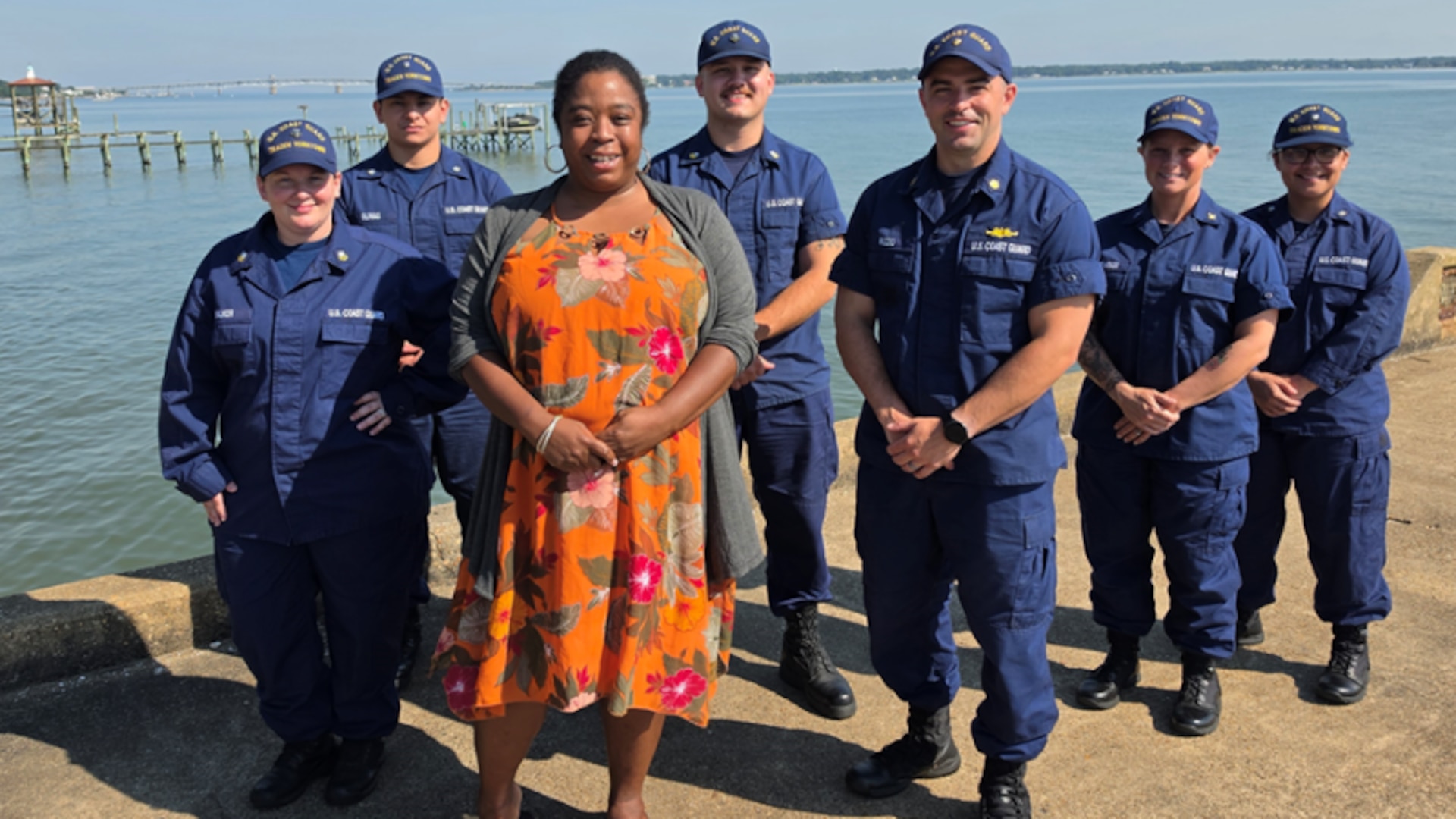 Coast Guard civilian Ronette Rhoden stands with military members from her TRACEN Yorktown unit on the base pier in Yorktown, Virginia on June 17, 2026.  Their support and dedication to the Coast Guard’s new Physical Readiness Program (PRP), she says, inspired her to get back into fitness. From left to right: SK1 Catherine Walker, SK3 Dominic Olivas, Rhoden, SK1 Roy Follman, Lt Cmdr. James Rizzo, Chief Warrant Officer Katie Underwood, SK3 Desteny Carranza-Velasquez. U.S. Coast Guard photo by Chief Warrant Officer Chad McNeil