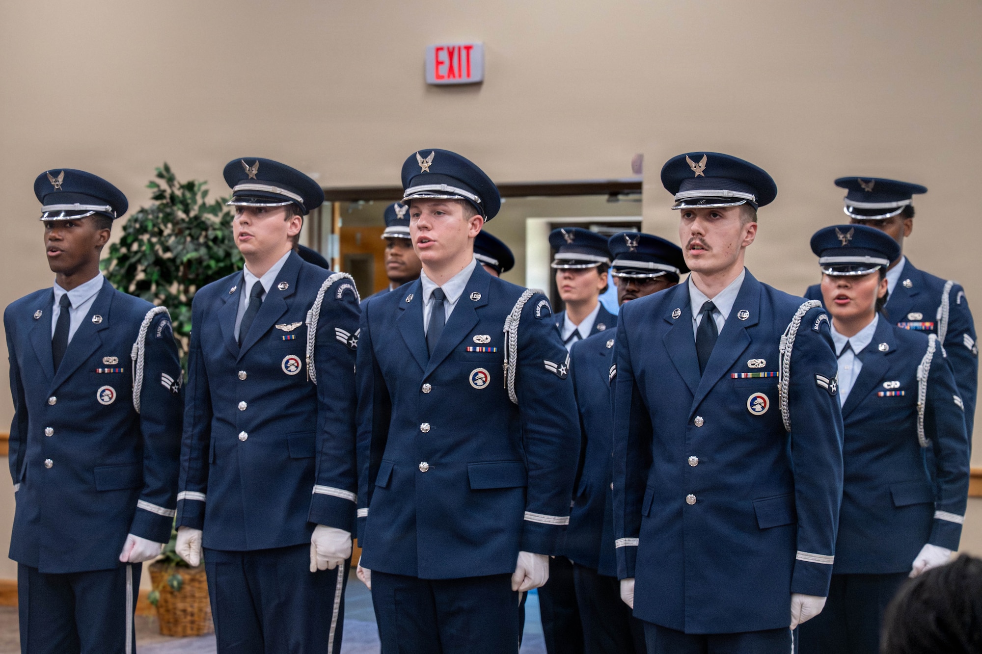 Honor Guard members recite the Honor Guard Creed inside of a building.