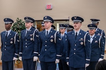Honor Guard members recite the Honor Guard Creed inside of a building.