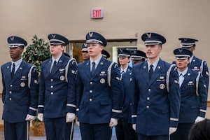 Honor Guard members recite the Honor Guard Creed inside of a building.
