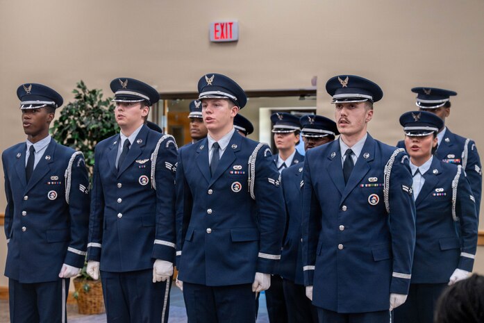 Honor Guard members recite the Honor Guard Creed inside of a building.