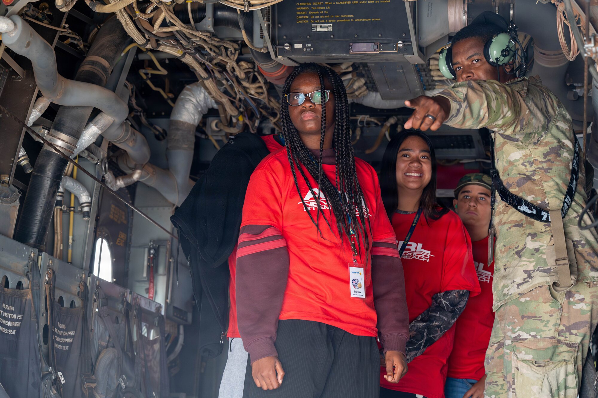 Members of the 58th Special Operations Wing showcase the interior of an aircraft to attendees of the Tuskegee Airmen Summer Camp at Kirtland Air Force Base.