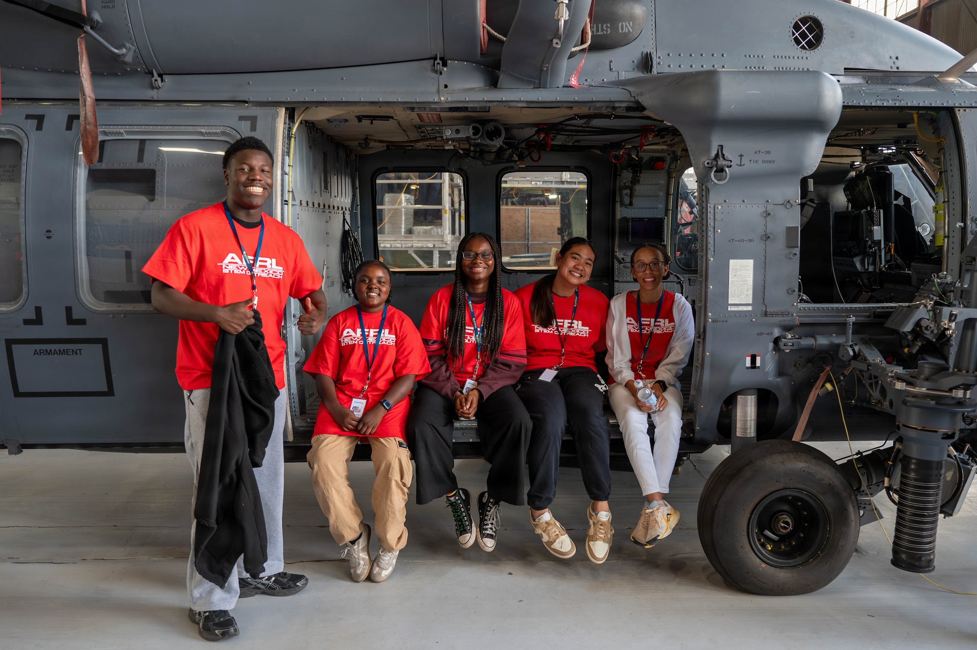 Attendees of the Tuskegee Airmen Summer Camp pose for a photo aboard an aircraft at Kirtland Air Force Base.