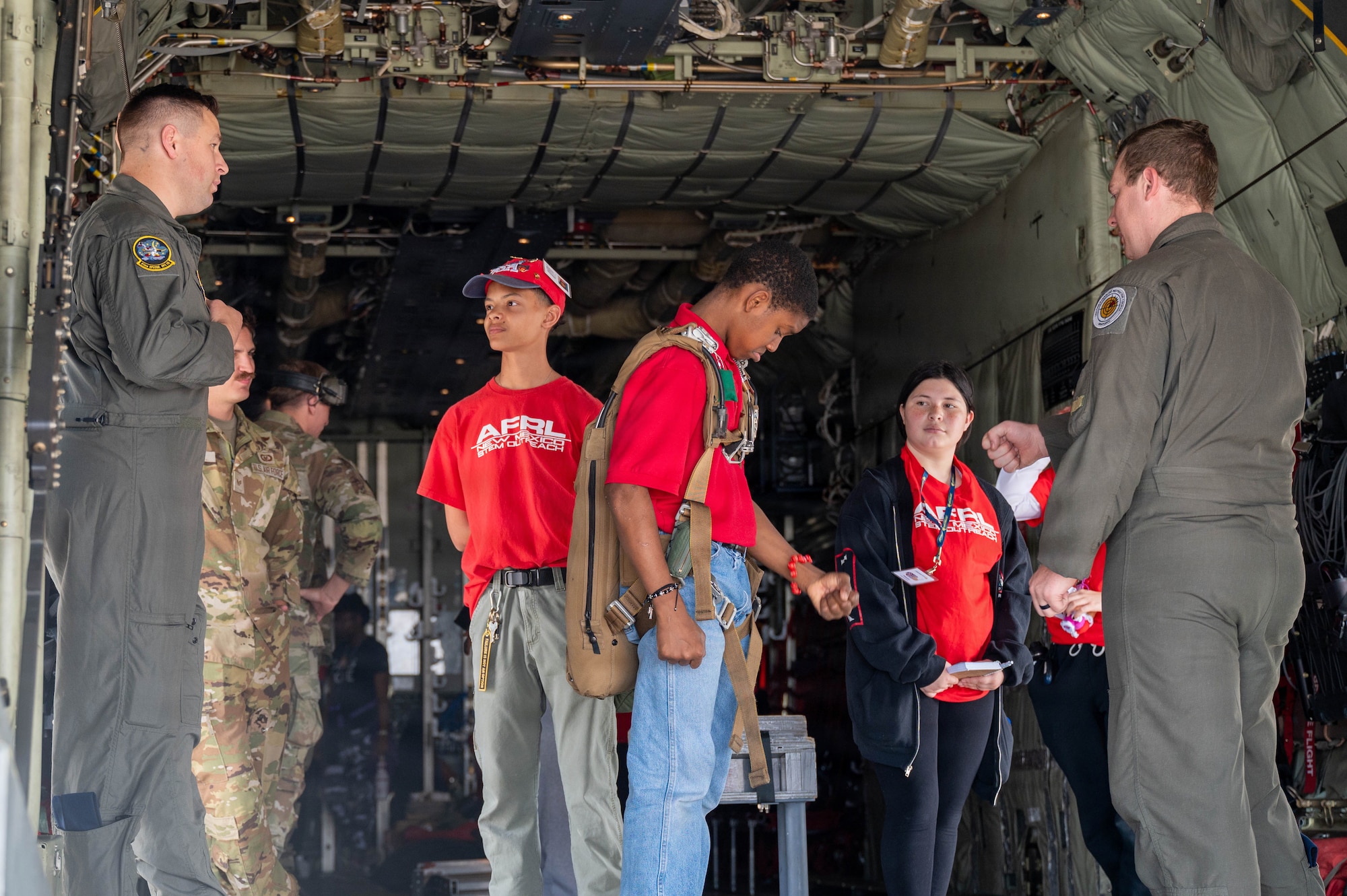 Members of the 58th Special Operations Wing showcase the interior of an aircraft to attendees of the Tuskegee Airmen Summer Camp at Kirtland Air Force Base.
