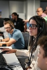 photo of US military members wearing civilian clothes working at computers