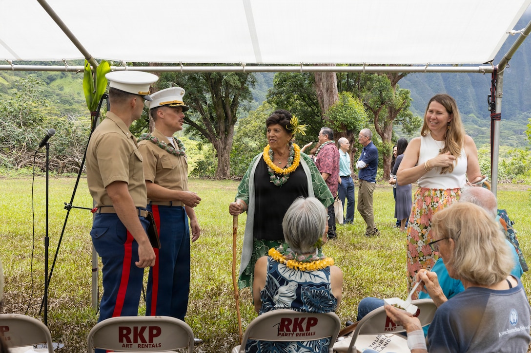 U.S. Marines and civilian employees with Marine Corps Base Hawaii (MCBH), converse with members of the Ko’olau Foundation and Ko’olaupoko Hawaiian Civic Club during the Kaneohe Pali Celebration at the Ho’omaluhia Botanical Garden in Kaneohe, Hawaii, June 10, 2026. The ceremony celebrated the State of Hawaii Division of Forestry and Wildlife's acquisition and permanent protection of over 950 acres of Kaneohe Pali. The project represents a successful partnership among federal, state, nonprofit, and military organizations that worked together to secure the land for the State of Hawaii, preventing future development while preserving critical watershed, cultural, and natural resources. (U.S. Marine Corps photo by Sgt. Jade K. Venegas)