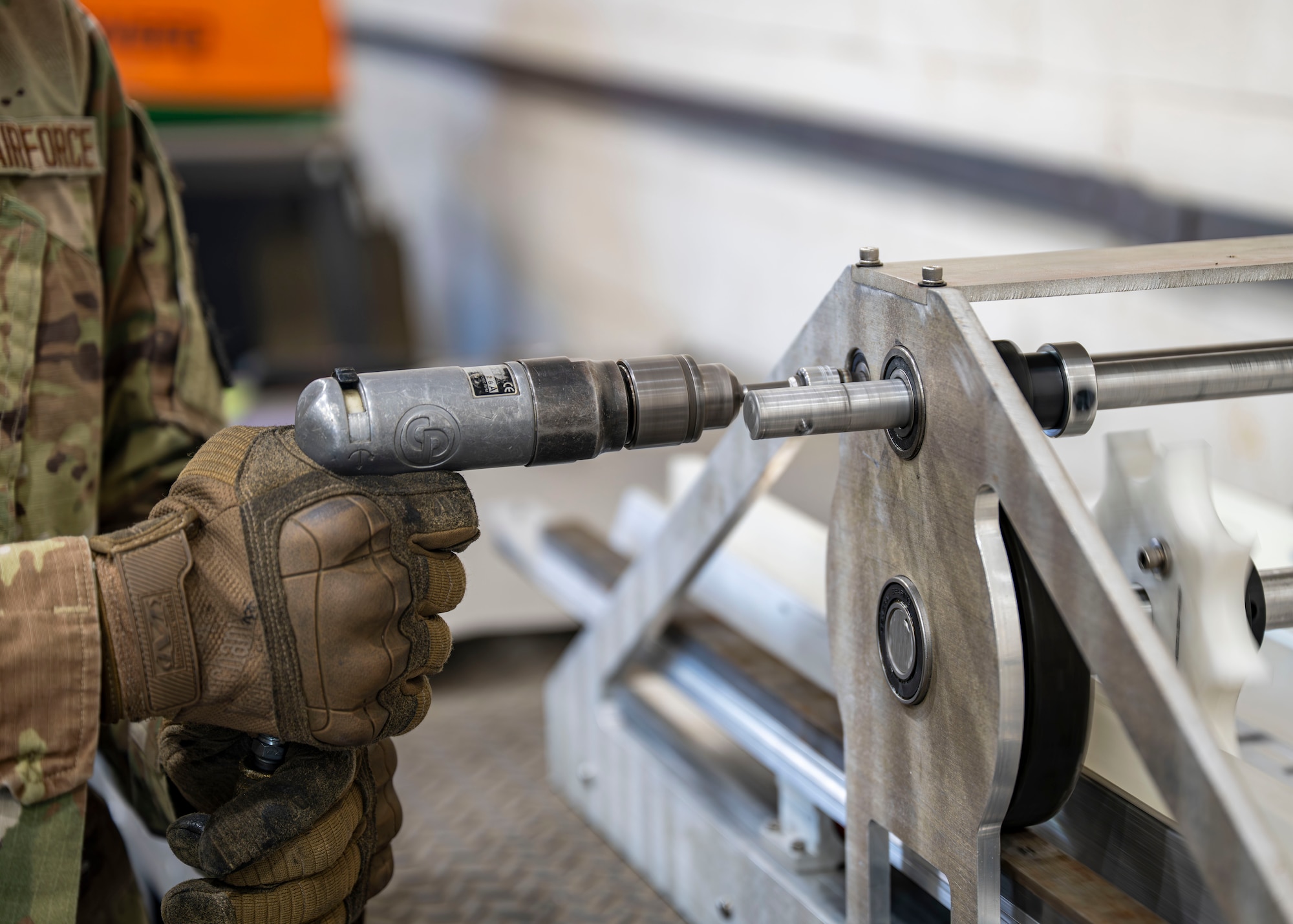 A munitions specialist assigned to the 1st Special Operations Wing operates a 30 mm ammunition linking machine