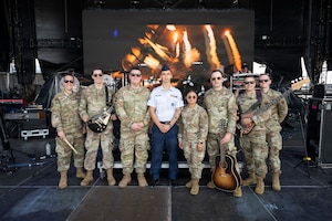 Members from the U.S. Air Force Heritage of America Band, and Senior Airman Roman Bereguta, U.S. Air Force Academy Preparatory School cadet-candidate, and one of the Outstanding Airmen of the Year for 2025, take a photo on the main stage of the Barefoot Country Music Fest in Wildwood, New Jersey, June 18, 2026.