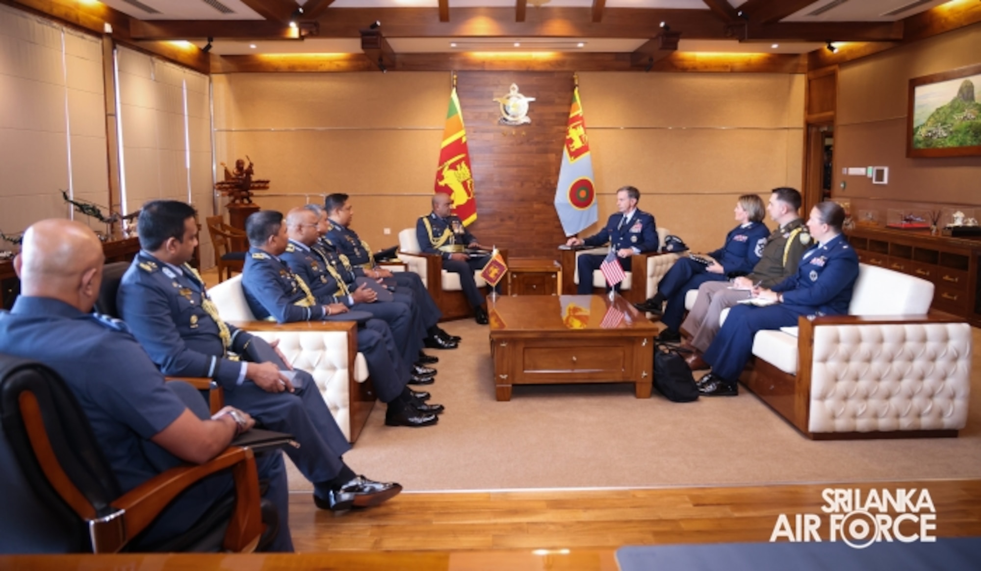 a dozen of senior military officials in formal dress sit in a board meeting.