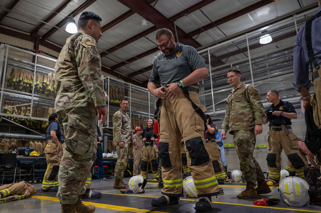 People don firefighting equipment
