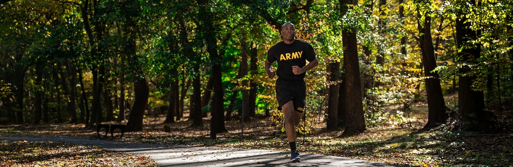 Goal Setting: Turning Intention Into Action Banner, Image of a Soldier running in the forest.
