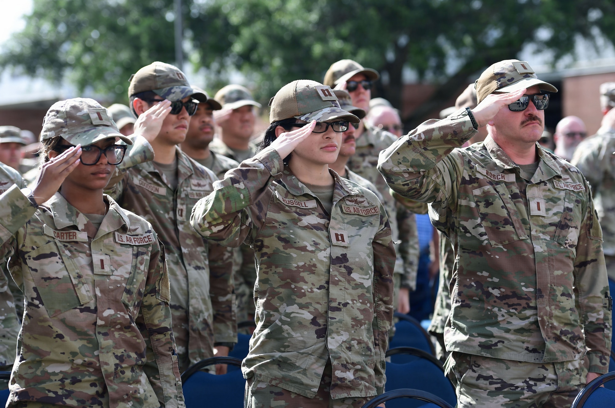 A group of Air Force Airmen render a salute.
