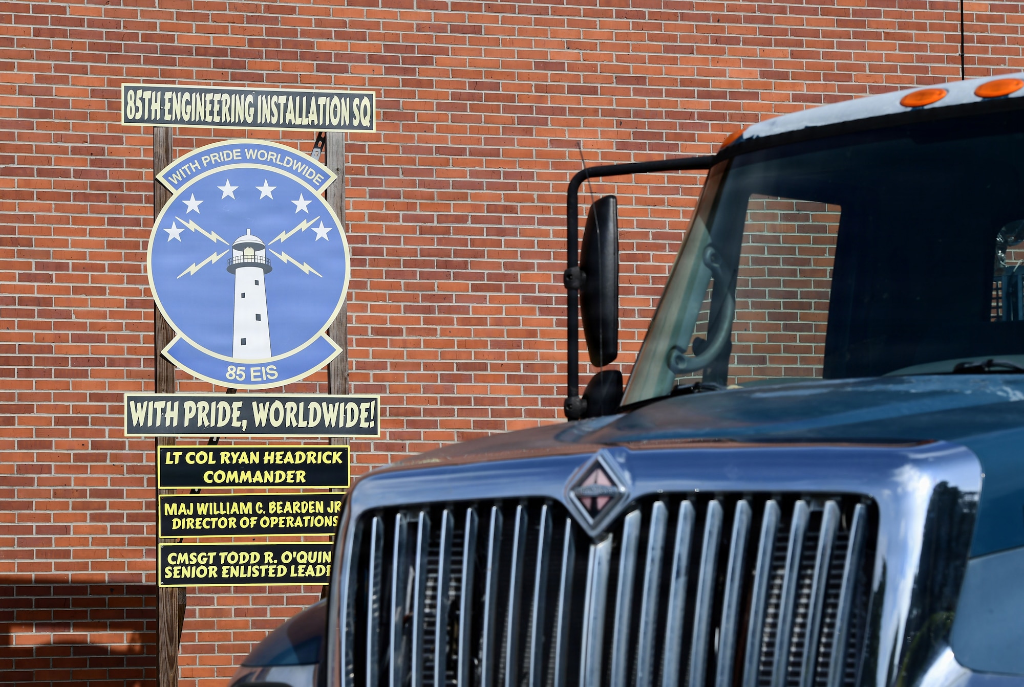 A sign is displayed outside with a blue truck in the foreground.