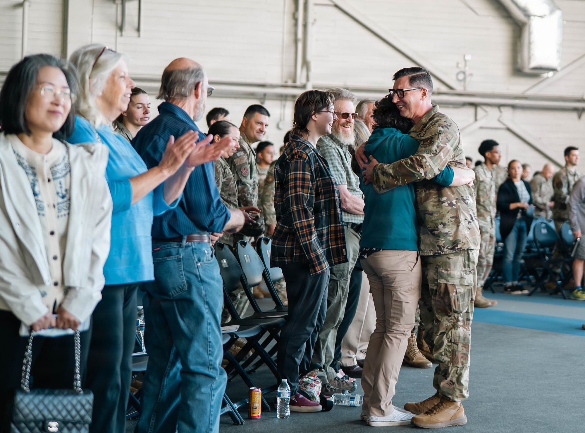 U.S. Air Force Col. Jacob Foley, new 673d Mission Support Group commander, hugs his family after the 673d MSG change-of-command on JBER, Alaska, June 18, 2026. The 673d MSG is composed of five squadrons – the 773d Force Support Squadron, the 673d Communications Squadron, the 673d Security Forces Squadron, the 673d Contracting Squadron and the 673d Force Support Squadron – providing support to the 673d Air Base Wing and 55 associate and tenant units assigned to JBER. (U.S. Air Force photo by Airman 1st Class Keola Vischi)