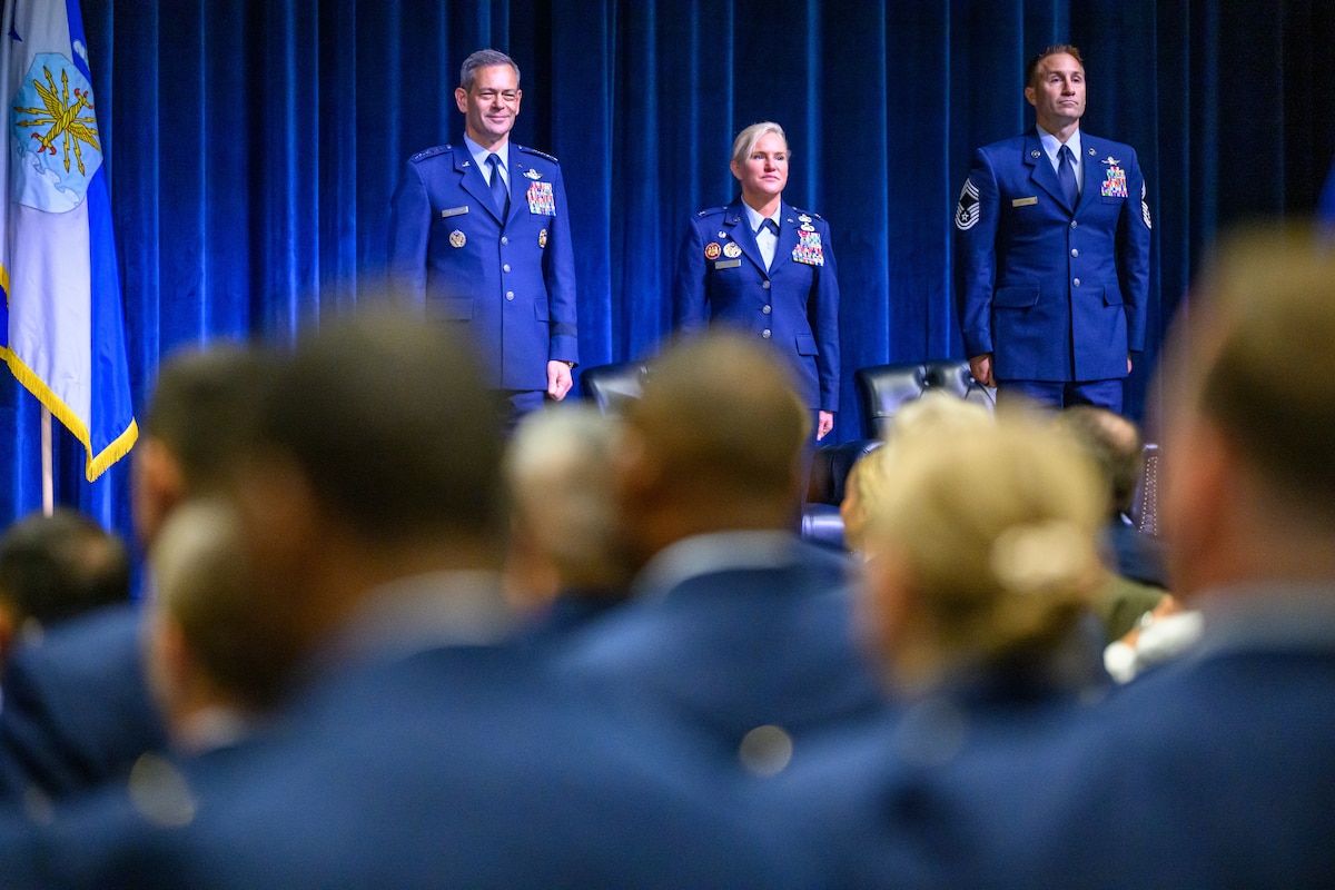.S. Air Force Chief of Staff Gen. Ken Wilsbach stands with OTS Commandant Colonel Roxanne Toy and Chief Master Sergeant Aaron Gufford at Officer Training School
