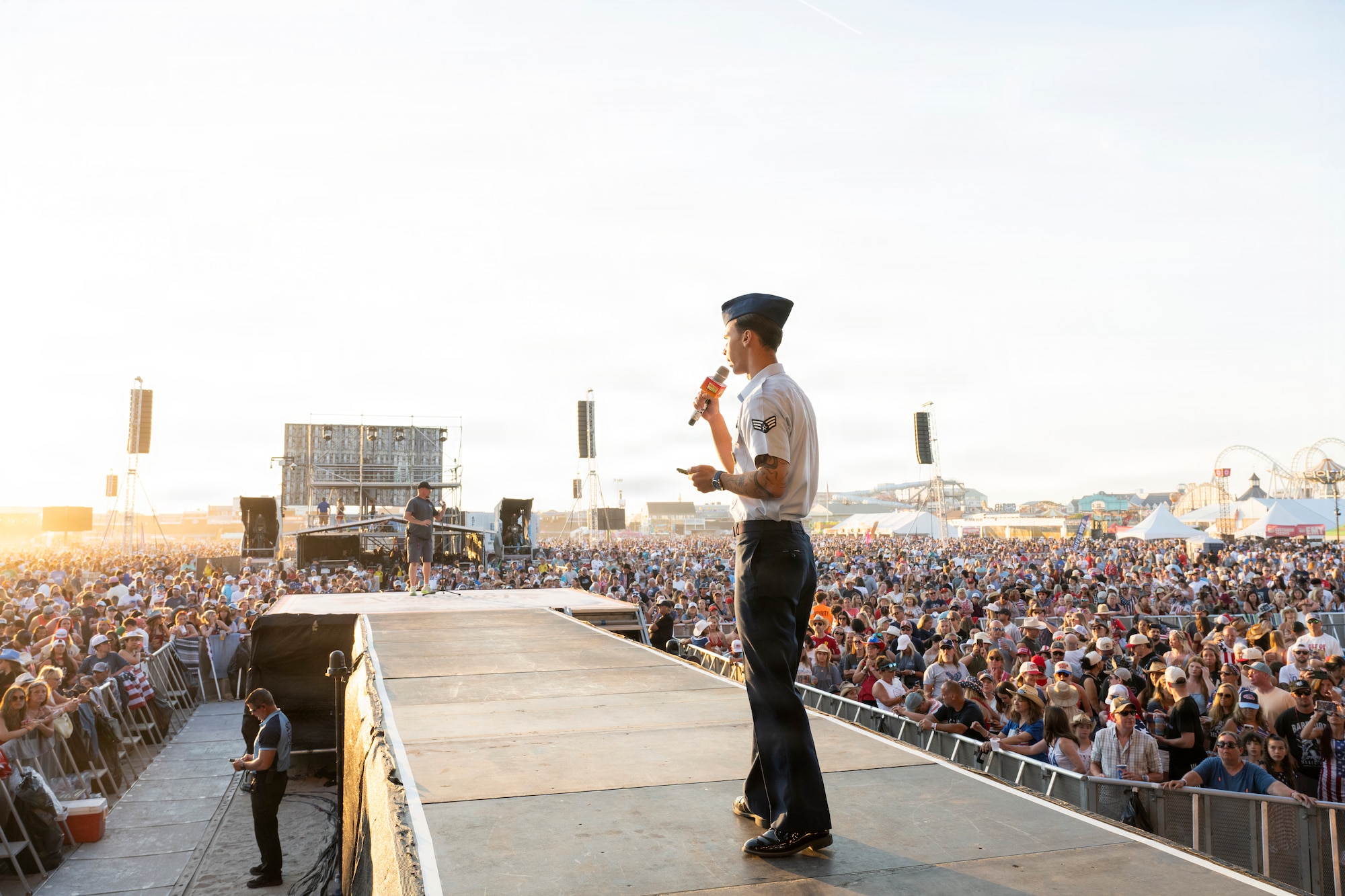 Senior Airman Roman Bereguta, U.S. Air Force Academy Preparatory School cadet-candidate, and one of the Outstanding Airmen of the Year for 2025, delivers opening remarks and introduces delayed entry program members for a swearing-in ceremony at the Barefoot Country Music Fest in Wildwood, New Jersey, June 21, 2026.