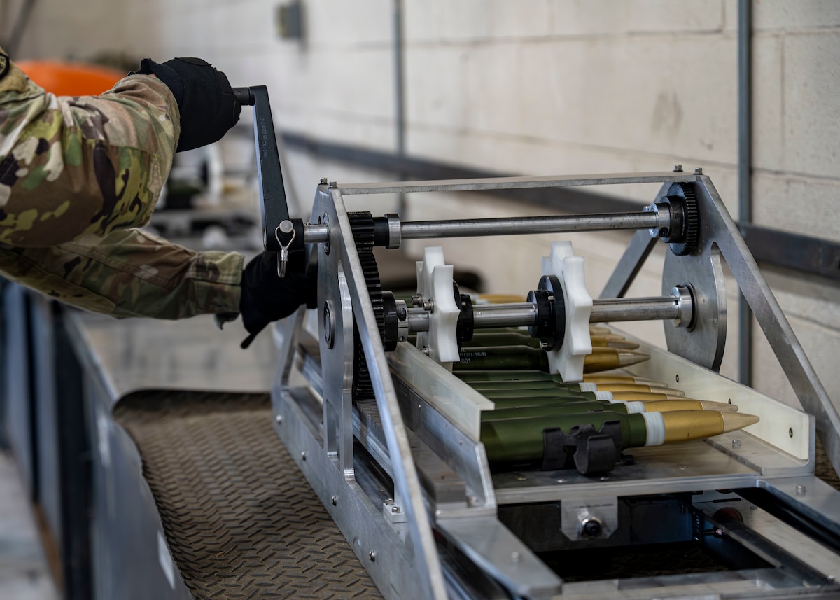 A munitions specialist assigned to the 1st Special Operations Wing operates a 30 mm ammunition linking machine