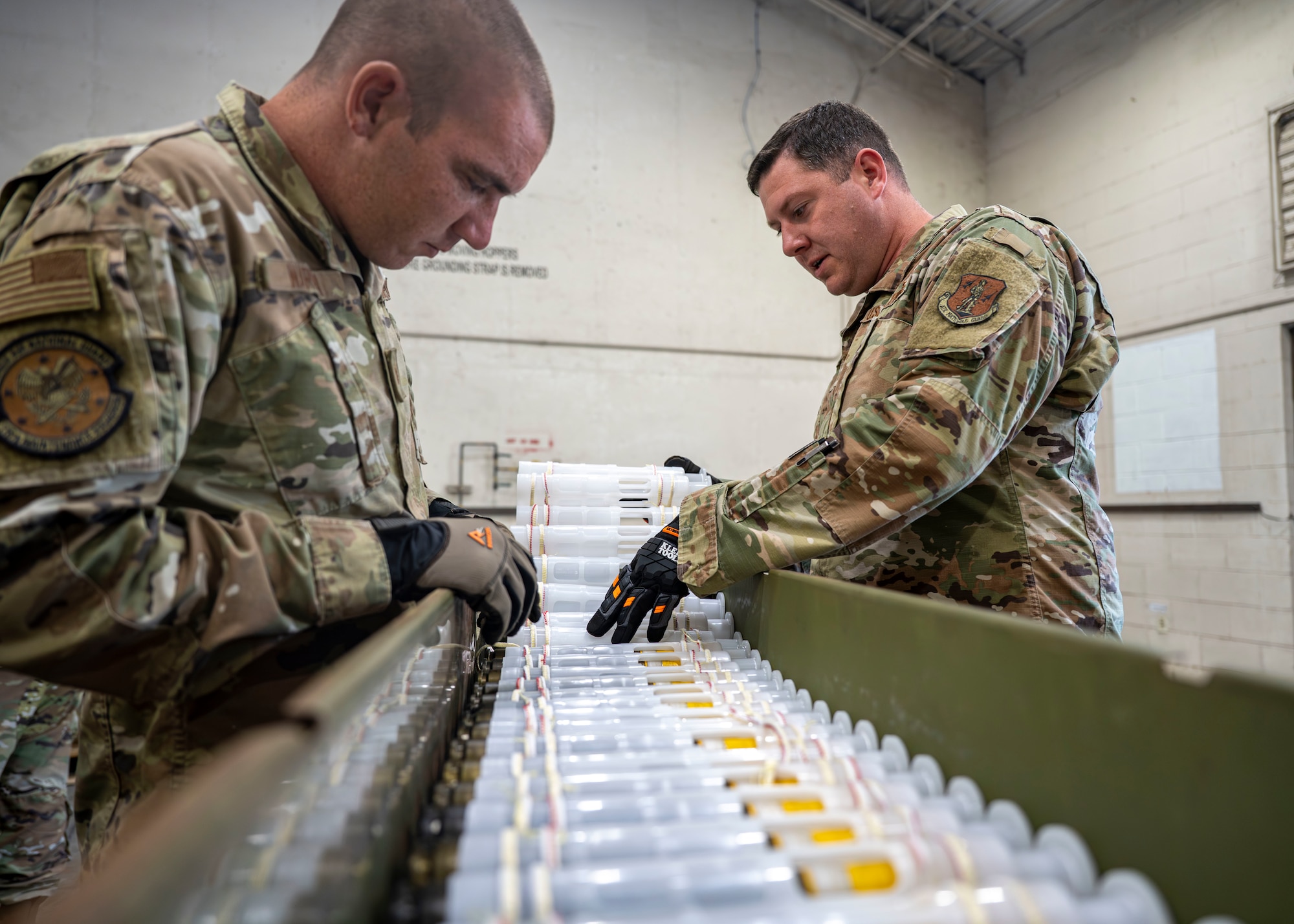Staff Sgt. Jesse Warren, avionics specialist, and Staff Sgt. Jaron Pollard, ordnance equipment mechanic, assigned to the Georgia Air National Guard’s 116th Maintenance Group, count 30 mm rounds