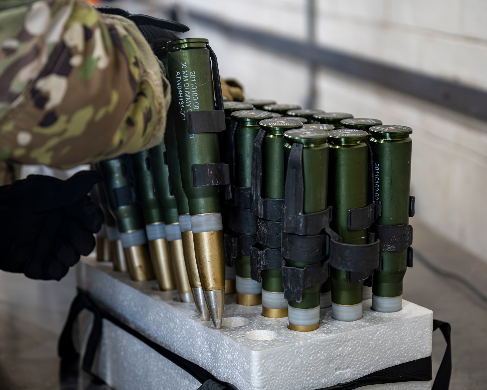 A munitions specialist assigned to the 1st Special Operations Wing packages 30 mm rounds