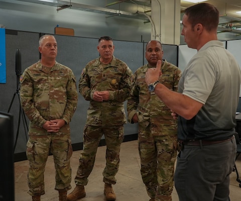 Brig. Gen. Ray Phariss, deputy commanding general, 311th Signal Command (Theater), and other senior leaders receive a capability briefing from an industry partner during the 2nd Mobile Brigade Tech Expo at Schofield Barracks, Hawaii, June 15, 2026.