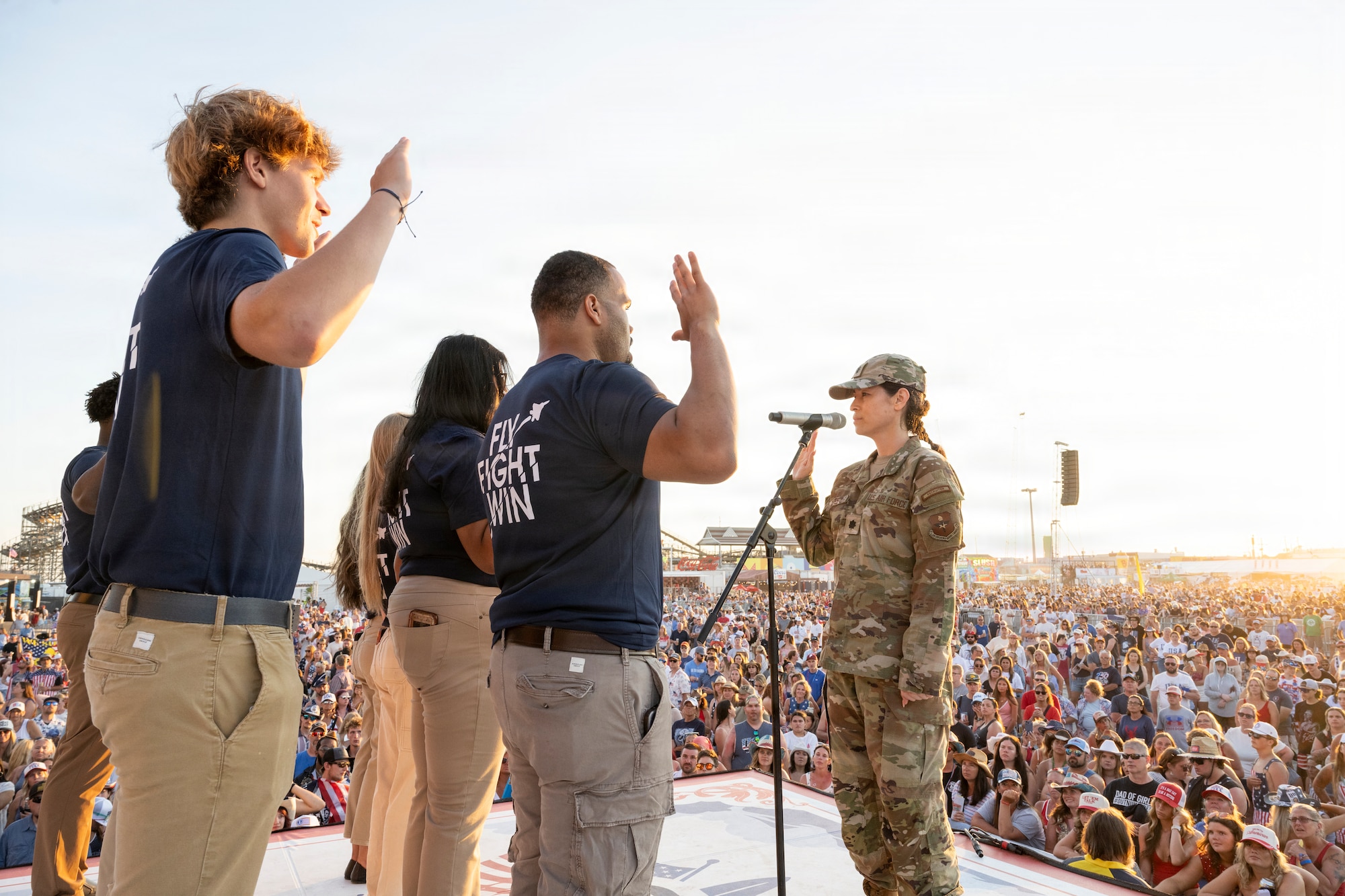 (Right) Lt. Col. Sarah Gates, 360th Recruiting Group deputy commander, administers the Oath of Enlistment to eight delayed entry program members at the Barefoot Country Music Fest in Wildwood, New Jersey, June 21, 2026.