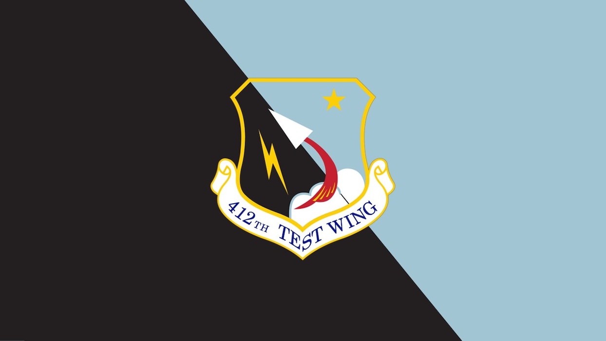 The official 412th Test Wing shield is depicted on a blue and black background. (U.S. Air Force graphic)