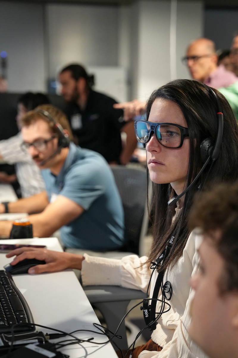 photo of US military members wearing civilian clothes working at computers