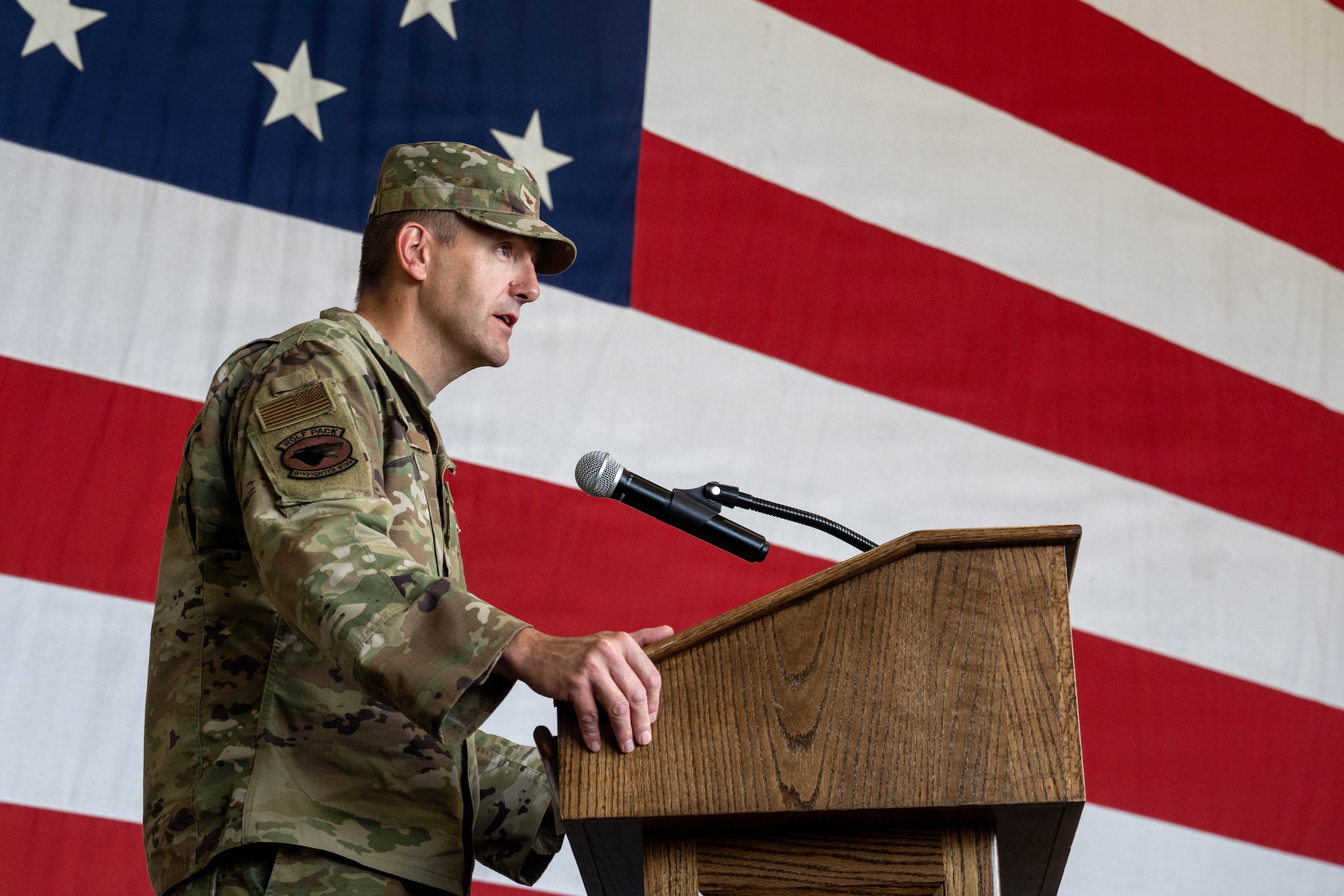 Commander speaks at podium.