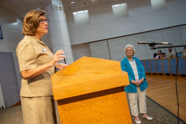 U.S. Navy Capt. Cindi Palacios, executive officer of Naval Medical Center San Diego (NMCSD), delivers remarks during the retirement ceremony for Carol Devine, executive assistant to the executive officer at NMCSD, June 24, 2026, as Devine looks on. Devine retired after 59 years of federal service, including 49 years at NMCSD. Throughout her career, Devine provided steadfast administrative leadership and continuity to generations of military and civilian leaders. The mission of NMCSD is to optimize health and enhance readiness. NMCSD employs more than 5,500 active-duty military personnel, civilians, and contractors in southern California to deliver exceptional care afloat and ashore. (U.S. Navy photo by Mass Communication Specialist 1st Class Marcus Stanley)