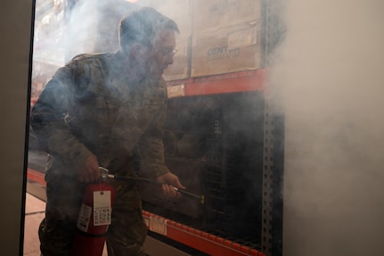 U.S. Air Force Tech. Sgt. Matthew Borges, a materiel management craftsman with the 102nd Logistics Readiness Squadron, puts out a simulated fire during the Patriots Resolve combat readiness inspection at Otis Air National Guard Base, Massachusetts, June 4, 2026.