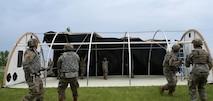 Airmen assigned to structures, 5th Civil Engineering squadron pull the top onto a small shelter system (sss) during the bivouac exercise at Fargo Air National Guard Base, North Dakota, May 31, 2026. The sss is a highly durable, modular, and climate-controlled tent built to handle extreme environments.