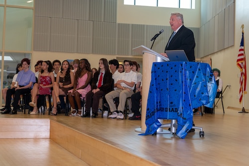 Image of person speaking to students.