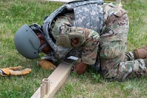 U.S. Air Force Airman 1st Class Alannique Jacobs, assigned to structures, 5th Civil Engineering Squadron builds the baseboards for a medium California tent during the bivouac exercise at Fargo Air National Guard Base, North Dakota, May 31, 2026. Medium California tents are capable of housing large assets, serving as a maintenance bay, or operating as a command center in extreme climates.