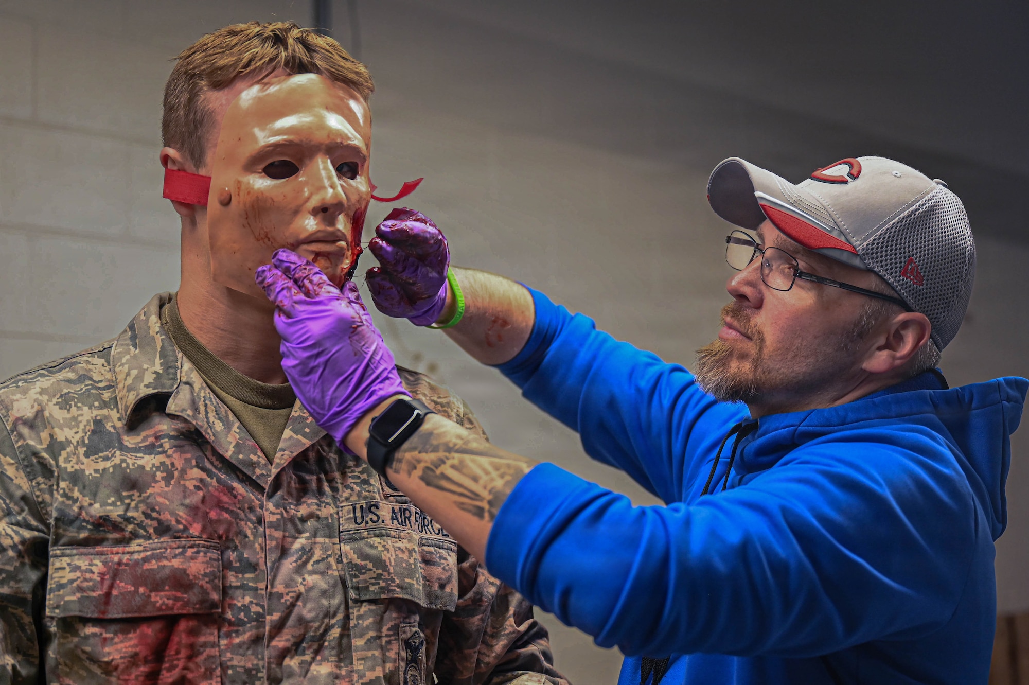 Brandon Baker, a member of the United States Air Force School of Aerospace Medicine, applies moulage to an airman from the 178th Wing during a Tactical Combat Casualty Care exercise in Springfield, Ohio, April 12, 2026. The training sharpened 178th Wing airmen's ability to triage and treat casualties in a simulated natural disaster scenario. (U.S. Air National Guard photo by Senior Airman Josh Kaeser)
