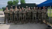 A group of Airmen from the 5th Force Support squadron pose in front of the expandable single pallet expeditionary kitchen (espek) at Fargo Air National Guard Base, North Dakota, May 31, 2026. The espek provides safe climate-controlled environments for food prep, cooking, and serving Airmen while in a deployed environment.